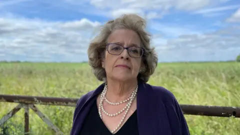 Alex Dunlop/BBC Lorna Sorrentino standing in front of a field