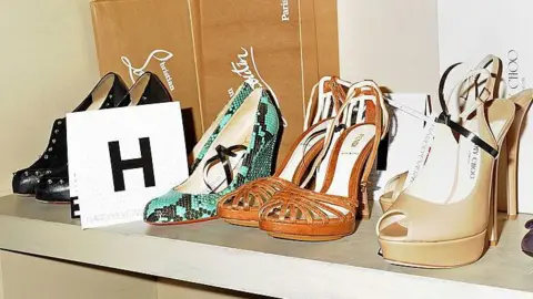 Four pairs of high-heeled shoes on a shelf at the hardlyeverwornit.com inaugural fashion evening at Mortons on May 10, 2012 in London. Next to them is a card with the letter H.