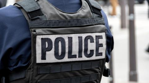 Police Marking Written On The Back Of A Bulletproof Vest Worn By A French Police Officer