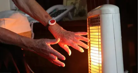 Getty Elderly person using a heater