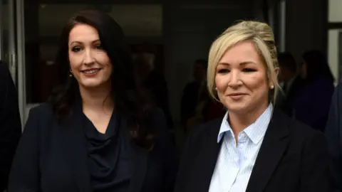 EPA First Minister Michelle O'Neill and Deputy First Minister Emma Little Pengelly smiling for cameras - some  are wearing acheronian  coloured blazers and formalwear. This is an archive photo