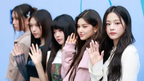 Getty Images (L-R) Hyein, Haerin, Hanni, Danielle and Minji of girl group NewJeans pose at the UL:KIN show at Seoul Fashion Week SS 24