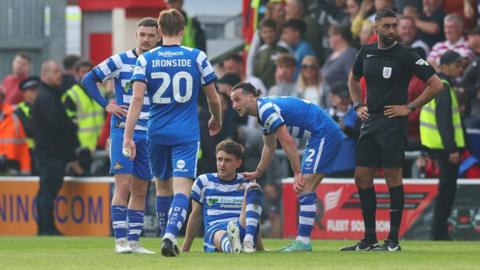Harrison Biggins of Doncaster Rovers reacts as he appears to be injured after celebrating scoring his side's second goal during the Sky Bet League Two Play-Off Semi-Final 1st Leg match between Crewe Alexandra and Doncaster Rovers at Mornflake Stadium on May 06, 2024 in Crewe, England