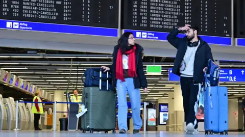 Getty Images Passengers wait at Frankfurt Airport on March 10, 2025 in Frankfurt, Germany.