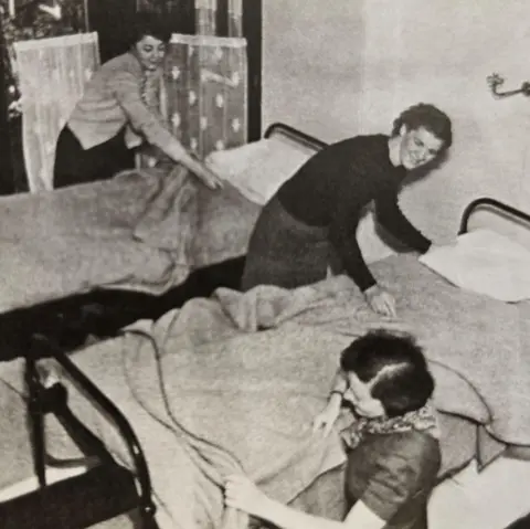 Hostelling Scotland A black and white picture showing three women are making up single beds.