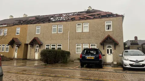 BBC Image of a house in St Clement with the roof ripped off