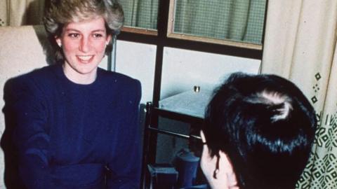 Princess Diana shakes hands with an Aids patient