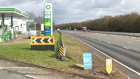 Google The Rowley Mile Services, showing part of the BP garage to the left and the three-lane A14 carriageway to the right.