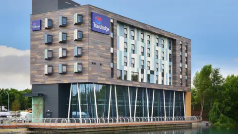 A Travelodge hotel on the side of a lake in Thurrock.