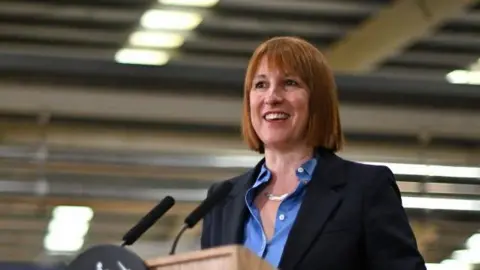 Getty Images A smiling Rachel Reeves standing at a podium