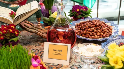 Pacific Press via Getty Images A traditional Haft Sin table with traditional items such as a bottle of vinegar laid out. 