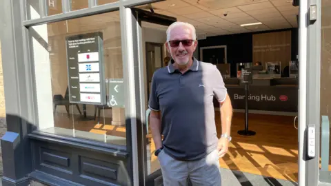 BBC/Seb Cheer Brian Good, standing outside the banking hub