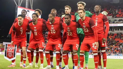Canada players pose for a team photo before a friendly against Ecuador in 2025