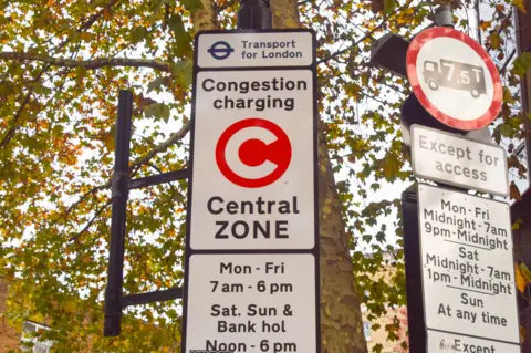 Getty Images TfL sign shows Large white Congestion Charge 'C' inside red box with Central Zone and times of the enforcement below