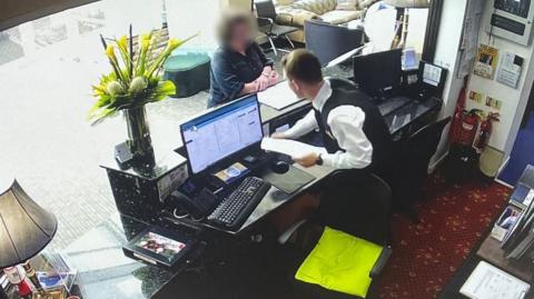 CCTV showing woman at reception desk