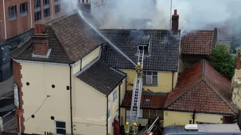 Fire crews tackling a fire in Norwich that forced a college to close