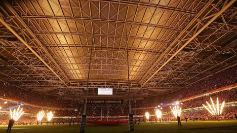 Getty Images Looking from a south to north pespective, the stadium's closed roof shows its stainless steel panels. Together, they measure 105 meters by 80 meters. Flames greet the teams during the RBS Six Nations match between Wales and France, in 2014 
