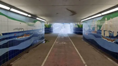 The A20 Townwall Street underpass in Dover, A cycle lane run through it and the walls are tiled blue and display nautical designs.   