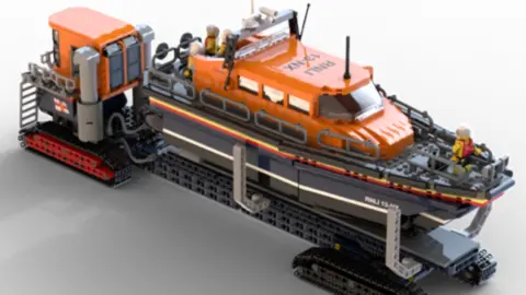 A LEGO version of the Shannon Class lifeboat. It has a green cabin above a blue hull. It is on a long mobile slipway.