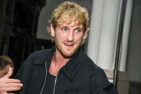 Getty Images Head and shoulders shot of Logan Paul with scruffy blonde hair and beard.