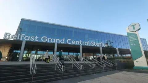 PA Media A glass building which has the words Belfast Grand Central Station in block silver letters on the front.