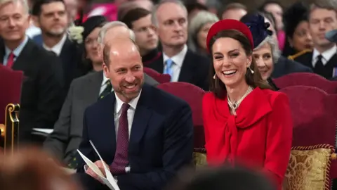 PA Media William and Catherine smile as they sit in the church.