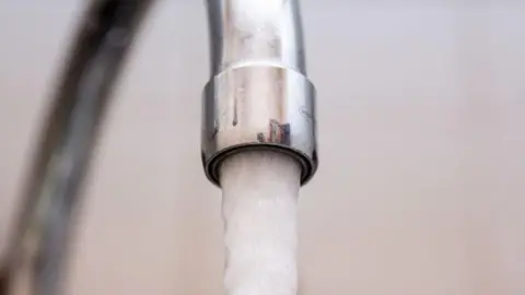 A tap is flowing with water. 