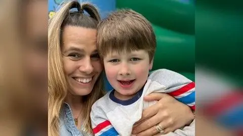 Handout Selina Clayton cuddling her son, who has non-verbal autism