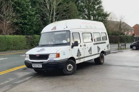 BBC/Seb Cheer An old white LDV Convoy minibus with poo emoji stickers all over the exterior. The number plate is PD02 BUS, appearing at first sight like 'poo bus'.