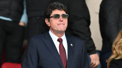 Dragan Solak looks on from the stands at St Mary's Stadium