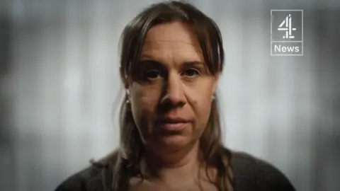 Channel 4 News Vicki Tomkins faces the camera. She has shoulder-length brown hair parted in the centre.