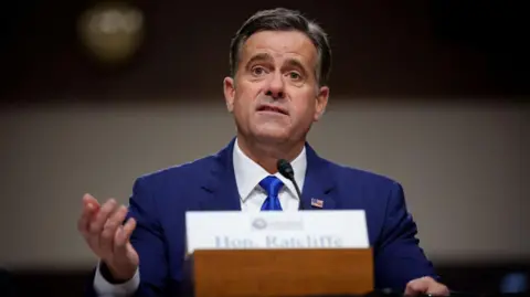 John Ratcliffe, wearing a blue shirt, white shirt and blue tie speaks during a Senate Intelligence confirmation hearing on Capitol Hill on January 15, 2025 in Washington, DC.