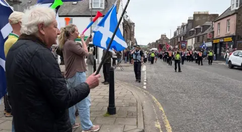 Some people waved saltires and hooted horns as the march went past