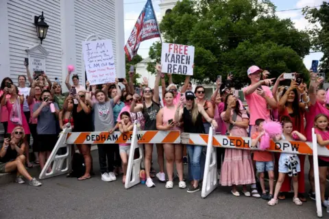 Getty Images Karen Read supporters gather outside the courthouse wearing pink