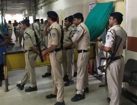 Police at the hospital where the girl is being treated