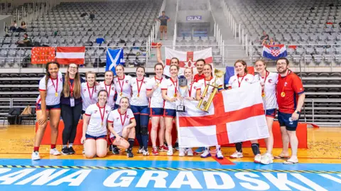 Supplied A dodgeball team with a trophy