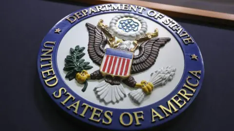 Anadolu via Getty Images A view of United States Department of State logo, which shows a coat of arms which features an eagle.
