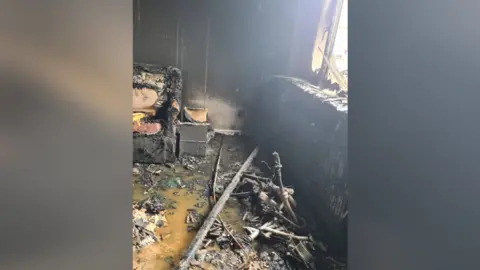 Leicestershire Fire and Rescue Service A fire -damaged front room