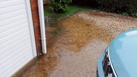 Flood water at the front of the property seeping into the garage