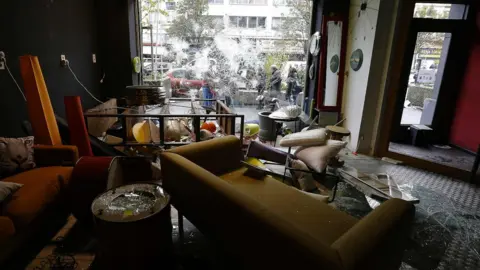 AFP/ Getty Images sofas and other furniture strewn across a business