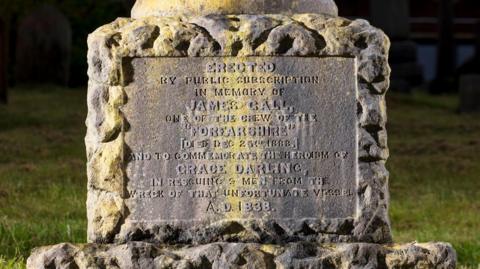 The monument's inscription bears the names of James Gall and Grace Darling. Many of the letters have worn away and are difficult to read    .