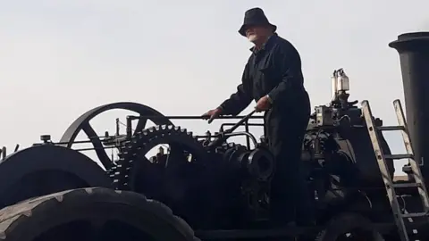 GDSF man near a steam engine