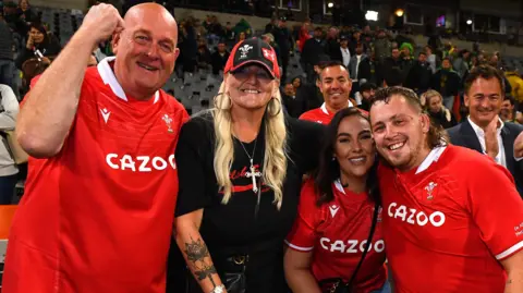Sam Wainwright (right) with his family after Wales' 2022 win in South Africa