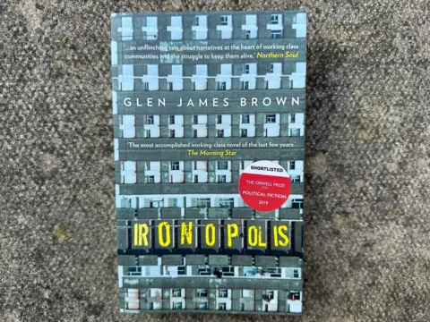 A book cover with a picture of a flat block and the word Ironopolis and the author's name on front