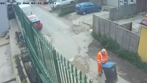 Met Police CCTV image of Paizan pushing a a wheelie bin, believed to contain the body of Agnes Akom