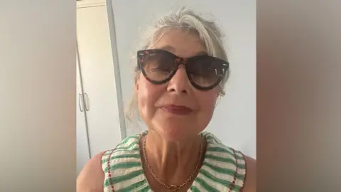 Supplied A woman wearing a striped top and sunglasses. She is looking at the camera 