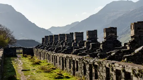 Getty Images Remains of slate quarrymen's cottages near Llanberis