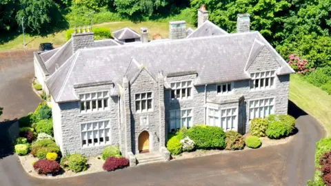 OKT An aerial view of the Bishop's House off the Armagh Road in Newry.   Built in 1932 from grey Newry granite, the imposing two-storey residence is four bays wide and has an arched oak front door.