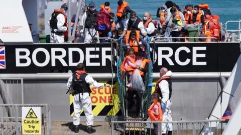 PA Media Migrants leave Border Force vessel in Dover on 5 August 2021 (file image)