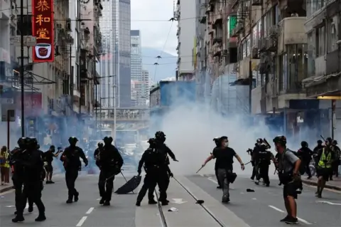 Reuters Riot police fire tear gas into the crowds to disperse anti-national security law protesters during a march at the anniversary of Hong Kong"s handover to China from Britain in Hong Kong, China July 1, 2020.